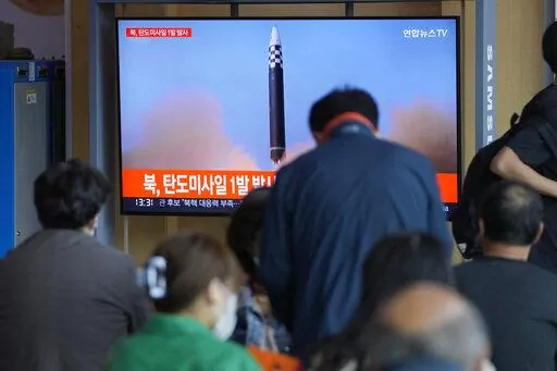 People watch a TV screen showing a news program reporting about North Korea's missile launch with file footage, at a train station in Seoul, South Korea, Wednesday, May 4, 2022. North Korea has launched a ballistic missile toward its eastern waters on Wednesday, South Korean and Japanese officials said, days after North Korean leader Kim Jong Un vowed to bolster his nuclear arsenal "at the fastest possible pace" and threatened to use them against rivals. (AP Photo/Lee Jin-man)
