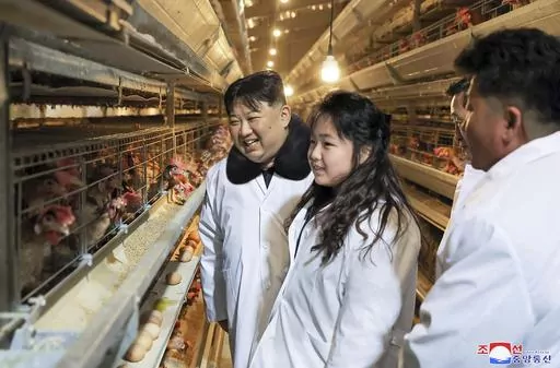 In this photo provided on Monday, Jan. 8, 2024, by the North Korean government, North Korean leader Kim Jong Un, center, with his daughter visits a newly-built chicken farm in Hwangju County of North Hwanghae Province on Jan. 7, 2024. Independent journalists were not given access to cover the event depicted in this image distributed by the North Korean government. The content of this image is as provided and cannot be independently verified. Korean language watermark on image as provided by sour