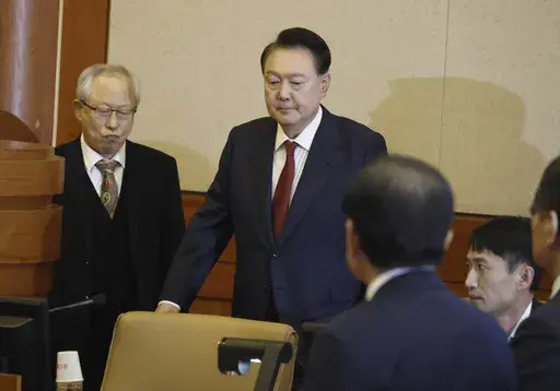 South Korea's impeached President Yoon Suk Yeol, center, attends the fourth hearing of his impeachment trial over his short-lived imposition of martial law at the Constitutional Court in Seoul, South Korea, Jan.23, 2025. (Jeon Heon Kyun/Pool Photo via AP)