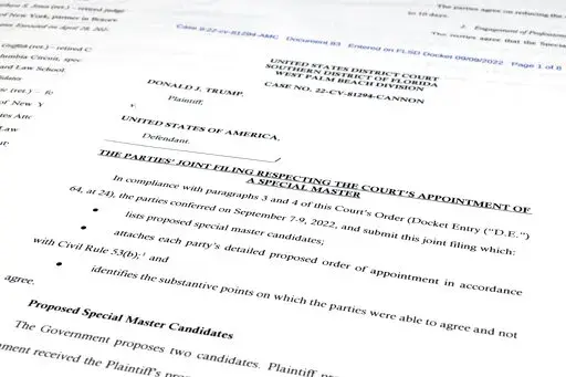Pages from a court filing by the Justice Department and former President Donald Trump's legal team of proposed candidates to server as an independent arbiter in the investigation into top-secret information seized by the FBI during a search of Trump's Mar-a-Lago estate, is photographed Thursday, Sept. 8, 2022. (AP Photo/Jon Elswick)