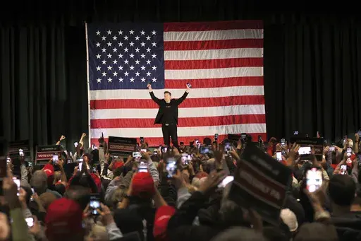 Elon Musk leads a America PAC Town Hall in Delaware County, Pa., at Ridley High School on Thursday, Oct. 17, 2024. (Charles Fox/The Philadelphia Inquirer via AP)
