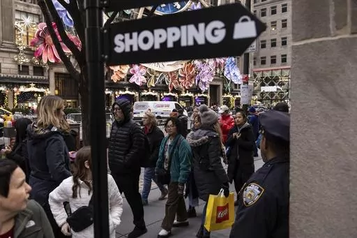 Shoppers and sightseers walk on Fifth Avenue on Dec. 11, 2023, in New York. In the United States, the economy motored ahead in last year's fourth quarter for a sixth straight quarter of growth since the pandemic's early days. (AP Photo/Yuki Iwamura, File)