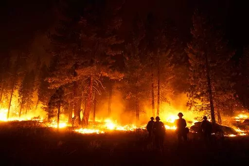 A firefighter lights a backfire to stop the Caldor Fire from spreading near South Lake Tahoe, Calif., Wednesday, Sept. 1, 2021. (AP Photo/Jae C. Hong)