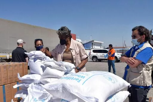 In this photo provided by the US Embassy in Turkey, Linda Thomas-Greenfield, U.S. Ambassador to the United Nations, examines aid materials at the Bab al-Hawa border crossing between Turkey and Syria, June 3, 2021. Supporters of a one-year extension of humanitarian aid deliveries from Turkey to 4.1 million Syrians in the rebel-held northwest, which Russia vetoed, are calling on Monday, July 11, 2022 for a Security Council vote on Moscow’s proposal for a six-month extension. (US Embassy in Turke