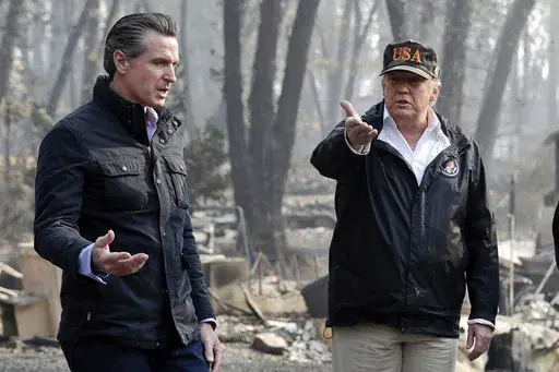 President Donald Trump talks with then California Gov.-elect Gavin Newsom, left, during a visit to a neighborhood impacted by the wildfires in Paradise, Calif., Nov. 17, 2018. (AP Photo/Evan Vucci, File)
