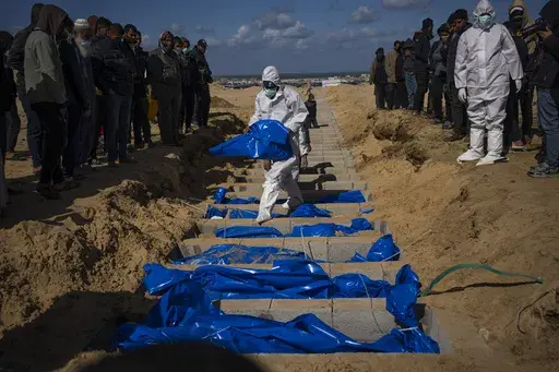 Palestinians bury the bodies of people who were killed in fighting with Israel and returned to Gaza by the Israeli military, during a mass funeral in Rafah, Gaza Strip, Tuesday, Jan. 30, 2024. (AP Photo/Fatima Shbair, File)