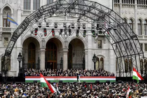 Hungary's right-wing populist prime minister, Viktor Orban addresses thousands of supporters as they gather in Budapest, Hungary, Tuesday, March 15, 2022. The so-called "peace march" was a show of strength by Orban's supporters ahead of national elections scheduled for April 3, while a coalition of six opposition parties also held a rally in the capital. (AP Photo/Anna Szilagyi)