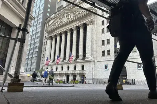 People pass the New York Stock Exchange on Aug. 27, 2024, in New York. (AP Photo/Peter Morgan, File)