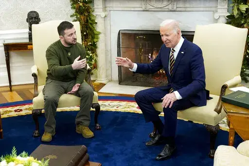President Joe Biden speaks with Ukrainian President Volodymyr Zelenskyy as they meet in the Oval Office of the White House, Dec. 21, 2022, in Washington. Support among the American public for providing Ukraine weaponry and direct economic assistance has softened as the Russian invasion nears a grim one-year milestone. (AP Photo/Patrick Semansky, File)