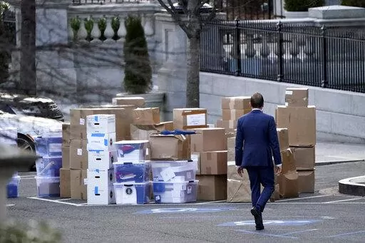 A man walks past boxes that were moved out of the Eisenhower Executive Office building, just outside the West Wing, inside the White House complex, Jan. 14, 2021, in Washington. At least three presidents. A vice president, a secretary of state, an attorney general. The mishandling of classified documents is not a problem unique to President Joe Biden and former President Donald Trump.(AP Photo/Gerald Herbert, File)