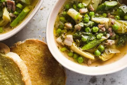 This image released by Milk Street shows a recipe for Tuscan-style spring vegetable soup. (Milk Street via AP)