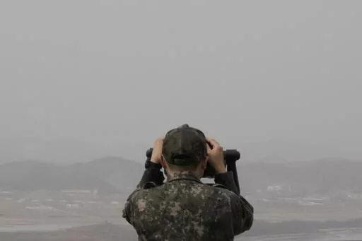 A South Korean army soldier watches the North Korea side from the Unification Observation Post in Paju, South Korea, near the border with North Korea, Friday, March 24, 2023. North Korea said Friday its cruise missile launches this week were part of nuclear attack simulations that also involved a detonation by a purported underwater drone as leader Kim Jong Un vowed to make his rivals "plunge into despair." (AP Photo/Ahn Young-joon)
