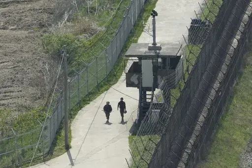 South Korean army soldiers patrol along the barbed-wire fence in Paju, South Korea, near the border with North Korea, on April 23, 2024. South Korean soldiers fired warning shots after North Korean troops violated the land border earlier this week, South Korea's military said Tuesday, June 11. (AP Photo/Ahn Young-joon, File)