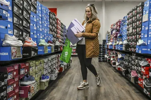 Ashley Crafton looks at tennis shoes at at Shoe Stop while shopping during Small Business Saturday in Wesleyan Park Plaza on Nov. 25, 2023, in Owensboro, Ky. (Greg Eans/The Messenger-Inquirer via AP, File)