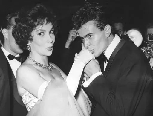 German actor Horst Buchholz kisses the hand of Italian actress Gina Lollobrigida, during the International Film Festival (Berlinale) in Berlin, Germany, July 5, 1958. (AP Photo/Werner Kreusch, File) Lollobrigida has died in Rome at age 95. Italian news agency Lapresse reported Lollobrigida’s death on Monday, Jan. 16, 2023 quoting Tuscany Gov. Eugenio Giani. (AP Photo/Werner Kreusch, File)