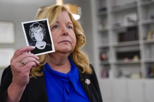Nassau County District Attorney Anne Donnelly holds a photo of Diane Cusick during an interview with The Associated Press, Wednesday, June 22, 2022, in Mineola, N.Y. More than 50 years after a woman was found dead in her car at a mall on Long Island, authorities prosecutors are expected to announce that DNA evidence has linked the slaying to Richard Cottingham, a serial killer who has been connected to 11 murders in New York and New Jersey between 1965 and 1980. (AP Photo/Mary Altaffer)