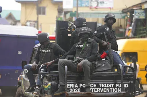 FILE- Police officers patrol during a protest by Nigeria Labour Congress on the street in Lagos, Nigeria, on July 26, 2022. Nigeria's police chief says hundreds of thousands of security forces are being deployed to ramp up safety in various troubled regions ahead of the country's Feb. 25 presidential election. More than 400,000 security personnel would be deployed for the vote in anticipation of challenges ranging from continued attacks by armed groups and suspected separatists targeting remote 