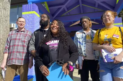 In this March 15, 2022 photo, Louisville mayoral candidate Shameka Parrish-Wright stands with volunteers and campaign staff at Shawnee Community Center in Louisville, Ky. In 2020, Parrish-Wright joined monthslong protests in downtown Jefferson Square Park, where she became a voice for protesters to the media.(AP Photo/Piper Hudspeth Blackburn)