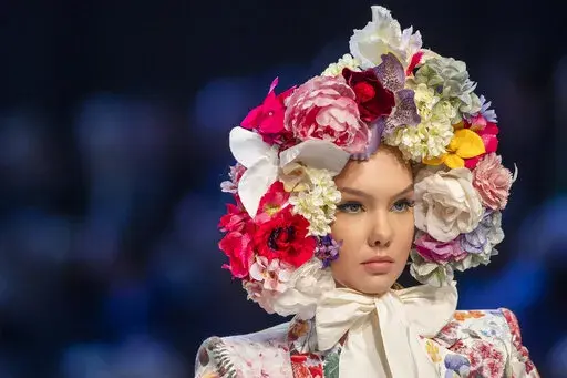 A model presents a creation from the Lithuanian designer Juozas Statkevicius' Haute Couture Spring-Summer 2022 fashion collection in Vilnius, Lithuania, Wednesday, Nov. 17, 2021. (AP Photo/Mindaugas Kulbis)