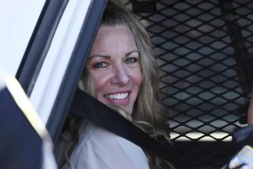Lori Vallow Daybell sits in a police car after a hearing at the Fremont County Courthouse in St. Anthony, Idaho, on Aug. 16, 2022. A mother charged with murder in the deaths of her two children is set to stand trial in Idaho. The proceedings against Lori Vallow Daybell beginning Monday, April 3, 2023, could reveal new details in the strange, doomsday-focused case. (Tony Blakeslee/East Idaho News via AP, Pool, File)