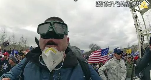 This image from police-worn body cam video contained in the statement of facts to support the arrest of Joseph Padilla, shows Padilla on the West Front of the U.S. Capitol on Jan. 6, 2021, in Washington. Padilla, who wrote on social media about wanting to "take over the Capitol building" before the Jan. 6, 2021 riot, where he threw a flagpole at a police officer's head, has been sentenced to more than six years in prison on Sept. 13, 2023. (Department of Justice via AP)