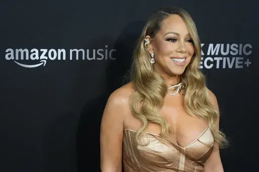 Mariah Carey arrives at the third annual Recording Academy Honors Presented by The Black Music Collective in Los Angeles on Feb. 1, 2024. Big record companies are suing artificial intelligence song generators Suno and Udio for copyright infringement, alleging that the AI music startups are exploiting the copyrighted works of artists from Carey to Chuck Berry. (AP Photo/Damian Dovarganes, File)