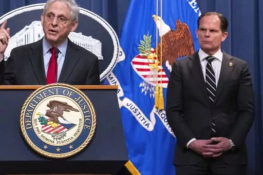 DEA Principal Deputy Administrator Louis Milione, right, stands behind Attorney General Merrick Garland during the announcement of an international law enforcement operation targeting fentanyl and opioid traffickers on the Darknet during a news conference at the Department of Justice, Tuesday, May 2, 2023, in Washington. In September 2023, Milione, the U.S. Drug Enforcement Administration’s recently departed second-in-command returned for a new stint with Guidepost Solutions, the high-powered 