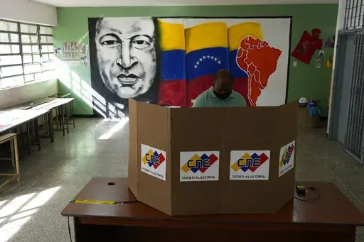 A man casts his vote during regional elections, at a polling station in Caracas, Venezuela, Sunday, Nov. 21, 2021. Venezuelans go to the polls to elect state governors and other local officials. (AP Photo/Ariana Cubillos)