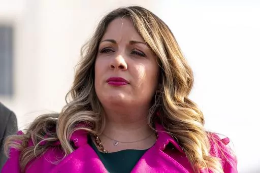 Lorie Smith, a Christian graphic artist and website designer in Colorado, appears outside the Supreme Court in Washington, Monday, Dec. 5, 2022, after her case was heard by the Court. In a defeat for gay rights, the Supreme Court's conservative majority ruled Friday, June 30, 2023, Smith who wants to design wedding websites can refuse to work with same-sex couples (AP Photo/Andrew Harnik, File)