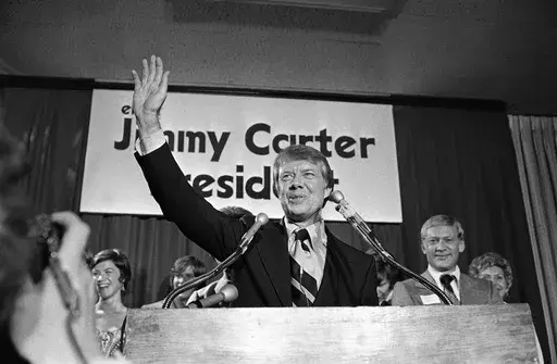 Georgia Gov. Jimmy Carter waves to a crowd gathered in Atlanta, Dec. 12, 1974, where he announced that he is a Democratic candidate for the presidency. Carter promised to "restore integrity, confidence and businesslike management to the federal government." (AP Photo, File)