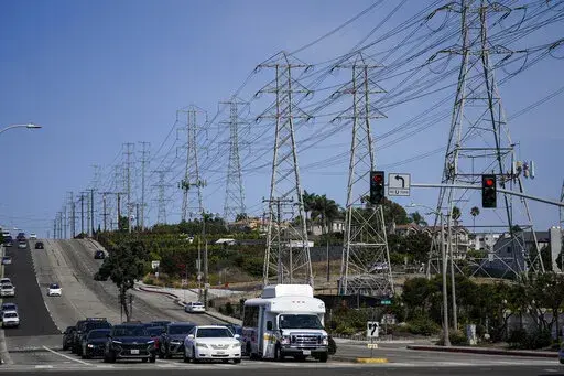 Power transmission towers line a street in Redondo Beach, Calif., Wednesday, Sept. 7, 2022. With record demand on power supplies across the West, California snapped its record energy use around 5 p.m. with 52,061 megawatts, far above the previous high of 50,270 megawatts set July 24, 2006. (AP Photo/Jae C. Hong)