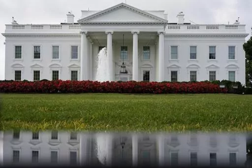 The White House is seen reflected in a puddle, Saturday, Sept. 3, 2022, in Washington. In a politically polarized nation, Americans seem to agree on one issue underlying the 2024 elections — a worry over the state of democracy and how the outcome of the presidential contest will affect its future. A poll from The Associated Press-NORC Center for Public Affairs Research found that 62% of adults say democracy in the U.S. could be at risk depending on who wins. That view is held by 72% of Democra