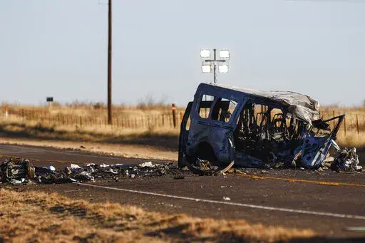 The damage bus sits on the side of the road at the scene of a fatal car wreck early Wednesday, March 16, 2022 half of a mile north of State Highway 115 on Farm-to-Market Road 1788 in Andrews County, Texas. A pickup truck crossed the center line of a two-lane road in Andrews County, about 30 miles (50 kilometers) east of the New Mexico state line on Tuesday evening and crashed into a van carrying members of the University of the Southwest men's and women's golf teams, said Sgt. Steven Blanco of t
