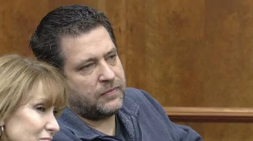This image taken from video provided by WTVG shows Pastor of Dad's Place Chris Avell, right, sitting inside Bryan Municipal Court on Thursday, Jan. 11, 2024, in Bryan, Ohio. The Christian church filed a federal lawsuit Monday, Jan. 22, after being charged with violating the zoning laws in the northwestern Ohio city by opening up the church around-the-clock for homeless residents and others to find shelter. (WTVG via AP)