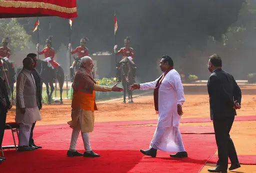 Indian Prime Minister Narender Modi, center left, greets his then Sri Lankan counterpart Mahinda Rajapaksa, during a ceremonial reception at the Indian presidential palace, in New Delhi, India, Saturday, Feb. 8, 2020. Sri Lanka's strategic location has attracted outsized interest in the small island nation from regional giants China and India for more than a decade, with Beijing and its free-flowing loans and infrastructure investments widely seen as having gained the upper hand in the quest for