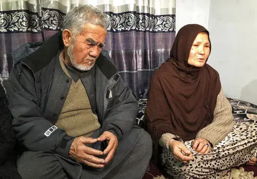 Zenaib Abdullahi's mother Mariam, right, and father father Nadir Ali, give an interview to The Associated Press at their family home in Kabul, Afghanistan, Jan. 17, 2022. On a recent night in Kabul, a Taliban security guard at a checkpoint in Kabul opened fire on a car carrying Zenaib's family home from a wedding, killing 25-year-old Zenaib. Taliban officials say the  shooting was a mix-up. But Zeinab’s death highlights one dilemma facing Afghanistan’s new rulers as they move from waging an 