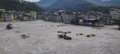 Buildings are inundated after flash floods triggered by sudden heavy rainfall swamped Rangpo town in Sikkim, India, Friday, Oct. 6. 2023. A flood that burst through a major hydroelectric dam in India's Himalayan northeast killed at least 31 people, officials said Friday, as ice-cold water swept through mountain towns, washing away houses and bridges and forcing thousands of people to leave their homes. The flood began shortly after midnight Wednesday, when a glacial lake high in the mountains ov