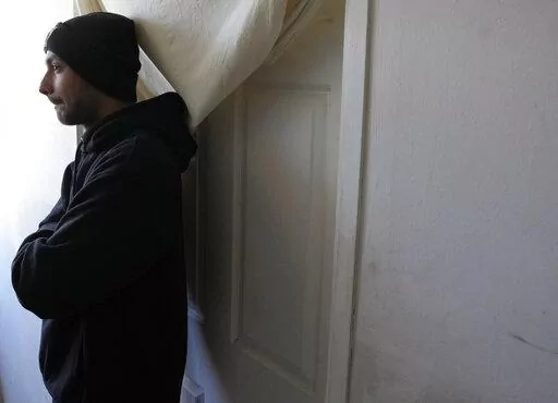 Hasib Qarizada a student from Afghanistan stands outside his room in the "Krnjaca" refugee centre near Belgrade, Serbia, Thursday, Feb. 24, 2022. While tens of thousands of refugees from Ukraine have found safety and help in Hungary, thousands of others weren't so lucky. Among them was Hasib Qarizada, a 25-year-old student from Afghanistan. He had been studying in Hungary for years butwas expelled last September even as his native country unraveled. (AP Photo/Darko Vojinovic)