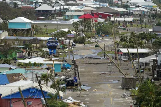 The remains of destroyed homes and businesses are seen in the aftermath of Hurricane Ida in Grand Isle, La., Tuesday, Aug. 31, 2021. (AP Photo/Gerald Herbert)