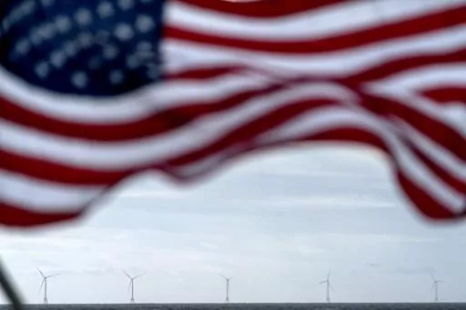 The five turbines of America's first offshore wind farm, owned by the Danish company, Orsted, are seen from a tour boat flying the American flag off the coast of Block Island, R.I., Oct. 17, 2022. The cancellation of two large offshore wind projects in New Jersey is the latest in a series of setbacks for the nascent U.S. offshore wind industry, jeopardizing President Joe Biden's goal of powering 10 million homes by towering ocean-based turbines by the end of the decade. (AP Photo/David Goldman, 