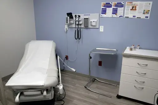 An exam room is seen inside Planned Parenthood on March 10, 2023. A lawsuit filed by 17 states challenging federal rules entitling workers to time off and other accommodations for abortions lacks standing, a federal judge in Arkansas ruled on Friday, June 14, 2024 (AP Photo/Jeff Roberson, File)