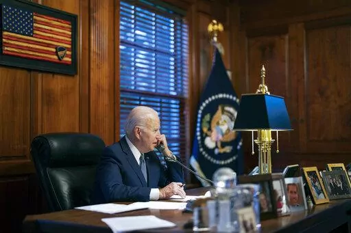 In this file image provided by The White House, President Joe Biden speaks with Russian President Vladimir Putin on the phone from his private residence in Wilmington, Del., Dec. 30, 2021. Biden acknowledged on Thursday that a document with classified markings from his time as vice president was found in his “personal library” at his home in Wilmington, Delaware, along with other documents found in his garage, days after it was disclosed that sensitive documents were also found at the office