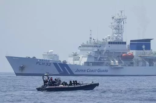 A Philippine Coast Guard rigid hull inflatable boat passes by the Japanese Coast Guard Akitsushima (PLH-32) during a trilateral Coast Guard drill of the U.S., Japan and Philippines, near the waters of the disputed South China See in Bataan province, Philippines, Tuesday, June 6, 2023. The United States, Japan and Australia are planning a joint navy drill in the South China Sea off the western Philippines this week to underscore their commitment to the rule of law in the region after a recent sho