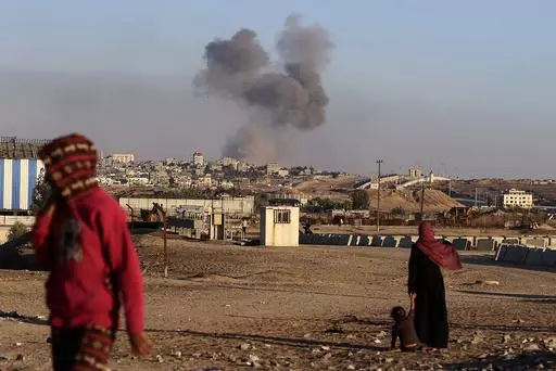 Smoke rises following an Israeli airstrike on buildings near the separating wall between Egypt and Rafah, southern Gaza Strip, Tuesday, May 7, 2024. An order by the top United Nations court for Israel to halt its military offensive in the southern Gaza city of Rafah deepens its disconnect with the United States. (AP Photo/Ramez Habboub, File)