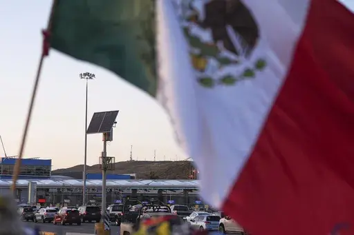 Vehicles wait in line to cross the border into the United States at the San Ysidro Port of Entry, Tuesday, March 18, 2025, in Tijuana, Mexico. (AP Photo/Gregory Bull, File)