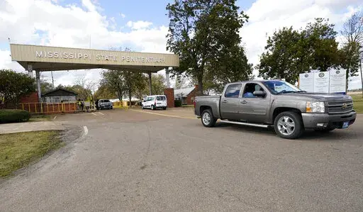 The front gate of the Mississippi State Penitentiary in Parchman, Miss., is shown Nov. 17, 2021. The U.S. Justice Department says it has found "severe, systemic" problems at the Mississippi State Penitentiary at Parchman. The department on Wednesday, April 20, 2022, released findings of its two-year investigation of Parchman, which began after an outburst of violence that left some inmates dead and others injured.  (AP Photo/Rogelio V. Solis, File)