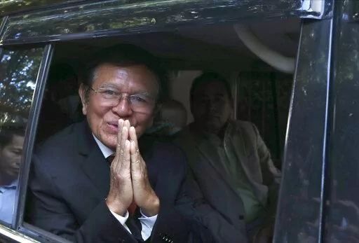 Former President of Cambodia National Rescue Party, Kem Sokha, greets from his car in front of his house in Phnom Penh, Cambodia, Friday, March 3, 2023. Cambodia’s beleaguered pro-democracy forces face another day of reckoning Friday, as the country’s most prominent opposition politician not in exile is scheduled to hear the verdict in his trial for treason.(AP Photo/Heng Sinith)