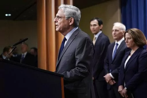 Attorney General Merrick Garland, joined by otters Justice officials, speaks to reporters as they announce charges against two men suspected of being Chinese intelligence officers for attempting to obstruct a U.S. criminal investigation and prosecution of Chinese tech giant Huawei, at the Department of Justice in Washington, Monday, Oct. 23, 2022. (AP Photo/J. Scott Applewhite)