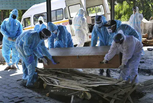 Health workers and relatives carry the body of a COVID-19 victim for cremation in Jammu, India, Sunday, April 25, 2021. The World Health Organization is estimating that nearly 15 million people were killed either by the coronavirus or by its impact on overwhelmed health systems in the past two years. That is more than double its official death toll. The U.N. health agency says most of the fatalities were in Southeast Asia, Europe and the Americas. In a report released Thursday, May 5, 2022 WHO c