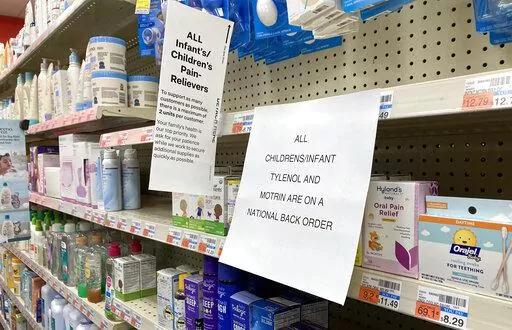 A sign is placed near the section for children's medicine, Sunday, Dec. 18, 2022 at a CVS in Greenlawn, N.Y. Caring for a sick child has become even more stressful than usual for many U.S. parents in recent weeks due to shortages of Children’s Tylenol and other medicines. (AP Photo/Leon Keith)